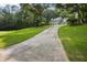 Beautiful home with a long driveway lined with lush greenery and featuring a well-manicured lawn at 285 Aspen Way, Fayetteville, GA 30214