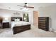 Bedroom with neutral walls, ceiling fan, dark furniture set and plush carpeting at 285 Aspen Way, Fayetteville, GA 30214