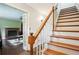 A staircase with wooden steps and white railings leading up with a view of the living room at 285 Aspen Way, Fayetteville, GA 30214
