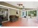Bright sunroom with tiled floors, comfortable seating, and large windows offering views of the outdoor landscape at 285 Aspen Way, Fayetteville, GA 30214