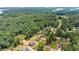 Aerial view of a neighborhood near a lake surrounded by lush greenery and scenic landscapes at 2855 Pilgrim Mill, Cumming, GA 30041