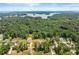Aerial view of a neighborhood near a lake surrounded by lush greenery and scenic landscapes at 2855 Pilgrim Mill, Cumming, GA 30041