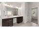 Bright bathroom features double sinks, quartz countertops, large mirror, and dark wood cabinetry at 2855 Pilgrim Mill, Cumming, GA 30041