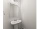 Bright powder room with simple pedestal sink, chrome fixtures, and neutral decor at 2855 Pilgrim Mill, Cumming, GA 30041