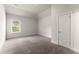 Neutral bedroom features carpeting, a window with blinds, and a white door at 2855 Pilgrim Mill, Cumming, GA 30041