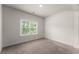 Bright bedroom featuring a window with blinds and neutral carpeting at 2855 Pilgrim Mill, Cumming, GA 30041
