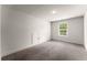 Carpeted bedroom featuring a window for ample natural light and a small storage closet at 2855 Pilgrim Mill, Cumming, GA 30041
