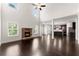 Open-concept living room with a stone fireplace and view into the modern kitchen at 2855 Pilgrim Mill, Cumming, GA 30041