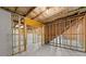 Unfinished basement has exposed wood framing and concrete flooring ready for customization at 2855 Pilgrim Mill, Cumming, GA 30041
