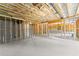 Vast unfinished basement area showcasing exposed beams, concrete walls, and painted floor at 2855 Pilgrim Mill, Cumming, GA 30041