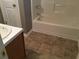 Clean bathroom showcasing a tub/shower combo, tile flooring, and a vanity sink at 318 Bakers Bridge Cir, Douglasville, GA 30134