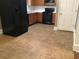 Well-lit kitchen with dark appliances, wood cabinets, and tile flooring at 318 Bakers Bridge Cir, Douglasville, GA 30134