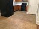 Well-lit kitchen with dark appliances, wood cabinets, and tile flooring at 318 Bakers Bridge Cir, Douglasville, GA 30134