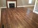 Spacious living room featuring sleek hardwood floors, a fireplace, and neutral wall paint at 318 Bakers Bridge Cir, Douglasville, GA 30134