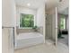 Inviting bathroom with soaking tub, separate shower, and bright window at 3481 Lakeview Crk, Lithonia, GA 30038