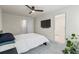 This bedroom features plush carpet, a modern ceiling fan, and a wall-mounted TV for relaxing evenings at 3481 Lakeview Crk, Lithonia, GA 30038