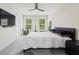 Sleek bedroom featuring a modern ceiling fan, queen-size bed and view to exterior at 3481 Lakeview Crk, Lithonia, GA 30038