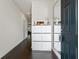 Modern entryway featuring dark hardwood floors, white storage and decor at 3481 Lakeview Crk, Lithonia, GA 30038