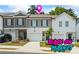 Charming townhome with a one-car garage and a well-maintained front yard and colorful flowers at 3481 Lakeview Crk, Lithonia, GA 30038