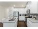 Modern kitchen featuring stainless steel appliances, white cabinets and granite countertops at 3481 Lakeview Crk, Lithonia, GA 30038
