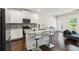 Contemporary kitchen boasts granite counters, stainless appliances, and island seating at 3481 Lakeview Crk, Lithonia, GA 30038