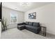 Cozy living room with a comfortable sectional sofa, modern lighting fixture, and stylish decor at 3481 Lakeview Crk, Lithonia, GA 30038