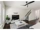 Living room featuring a view of the stairs, dark wood floors, a ceiling fan, and natural light at 3481 Lakeview Crk, Lithonia, GA 30038