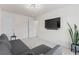 Cozy living room with TV, neutral colors, modern light fixture and lots of natural light at 3481 Lakeview Crk, Lithonia, GA 30038
