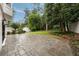 Stone patio leads to grassy backyard with mature trees and lush landscaping at 3916 E Brookhaven Ne Dr, Brookhaven, GA 30319