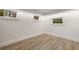 Bright basement area with wood-look flooring and multiple windows, offering a functional and versatile space at 3916 E Brookhaven Ne Dr, Brookhaven, GA 30319