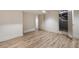 Basement area with wood-look flooring and access to utilities, offering a functional and versatile space at 3916 E Brookhaven Ne Dr, Brookhaven, GA 30319