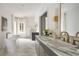 Bright bathroom features marble floors, soaking tub, and double vanity with gold fixtures at 3916 E Brookhaven Ne Dr, Brookhaven, GA 30319