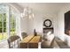 Bright dining room featuring modern chandelier, light walls, neutral chairs, and wooden floors at 3916 E Brookhaven Ne Dr, Brookhaven, GA 30319
