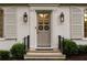 Close-up of the front door with decorative glass, sconces, and classic molding at 3916 E Brookhaven Ne Dr, Brookhaven, GA 30319