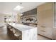 Open kitchen boasts a large marble island with seating, light cabinets, and modern lighting at 3916 E Brookhaven Ne Dr, Brookhaven, GA 30319