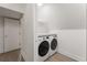 Convenient laundry room with modern washer and dryer units, complemented by sleek white shelving at 3916 E Brookhaven Ne Dr, Brookhaven, GA 30319