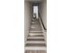 Elegant staircase with wooden steps, a black railing, and recessed lighting, leading to an inviting interior at 3916 E Brookhaven Ne Dr, Brookhaven, GA 30319