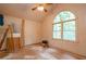 Bright bedroom with vaulted ceiling, large arched window, and ladder, showcasing a room in progress at 911 White Stag Ln, Canton, GA 30115