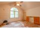Vaulted bedroom featuring large arched window, white ceiling fan and built-in cabinetry at 911 White Stag Ln, Canton, GA 30115
