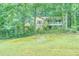 Charming home exterior nestled among trees with a well-manicured lawn at 911 White Stag Ln, Canton, GA 30115
