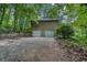 Exterior featuring the back of home with two car garage and a concrete driveway at 911 White Stag Ln, Canton, GA 30115