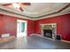 A spacious living room boasts a stone fireplace, ceiling fan, and open design at 911 White Stag Ln, Canton, GA 30115