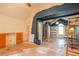 View of two living spaces with blue trim, vaulted ceilings, large windows and built in cabinetry, in need of renovation at 911 White Stag Ln, Canton, GA 30115