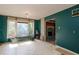 Living room featuring a large window and access to another room at 911 White Stag Ln, Canton, GA 30115