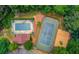 Aerial view of community amenities including a pool, tennis court, sand volleyball and surrounding greenery at 1415 Stoney Field Pl, Lawrenceville, GA 30043
