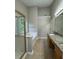 Spacious bathroom featuring a soaking tub with tile surround and double sink vanity at 1415 Stoney Field Pl, Lawrenceville, GA 30043