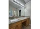 Bathroom featuring double sinks, granite countertops, bathtub and glass enclosed shower at 1415 Stoney Field Pl, Lawrenceville, GA 30043