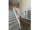 Bright entryway featuring a carpeted staircase with wood railing and glass panel doors to another room at 1415 Stoney Field Pl, Lawrenceville, GA 30043