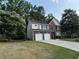 Spacious two-story home with attached two-car garage and a well-maintained lawn at 1415 Stoney Field Pl, Lawrenceville, GA 30043