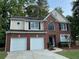 Beautiful two-story brick home with attached two-car garage, black shutters, and well-manicured landscaping at 1415 Stoney Field Pl, Lawrenceville, GA 30043